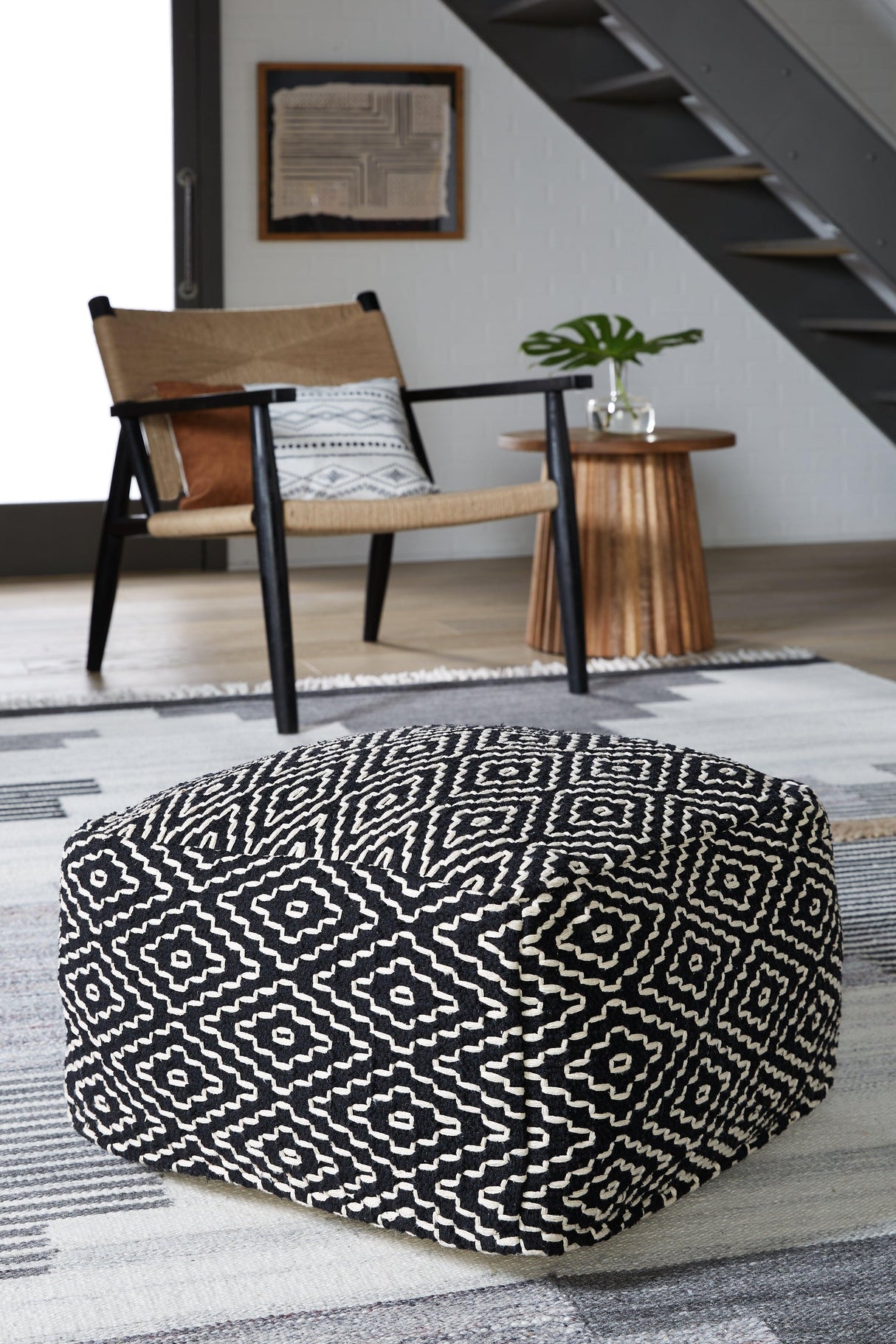 Jasett Black/Ivory Pouf by Ashley at Eve Furniture