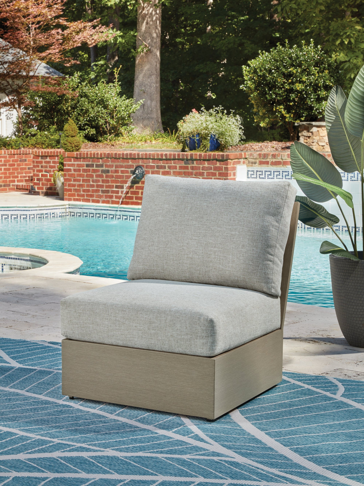 Kimpton Isle Brown/Beige Outdoor Armless Chair with Cushion by ASHLEY FURNITURE at Eve Furniture