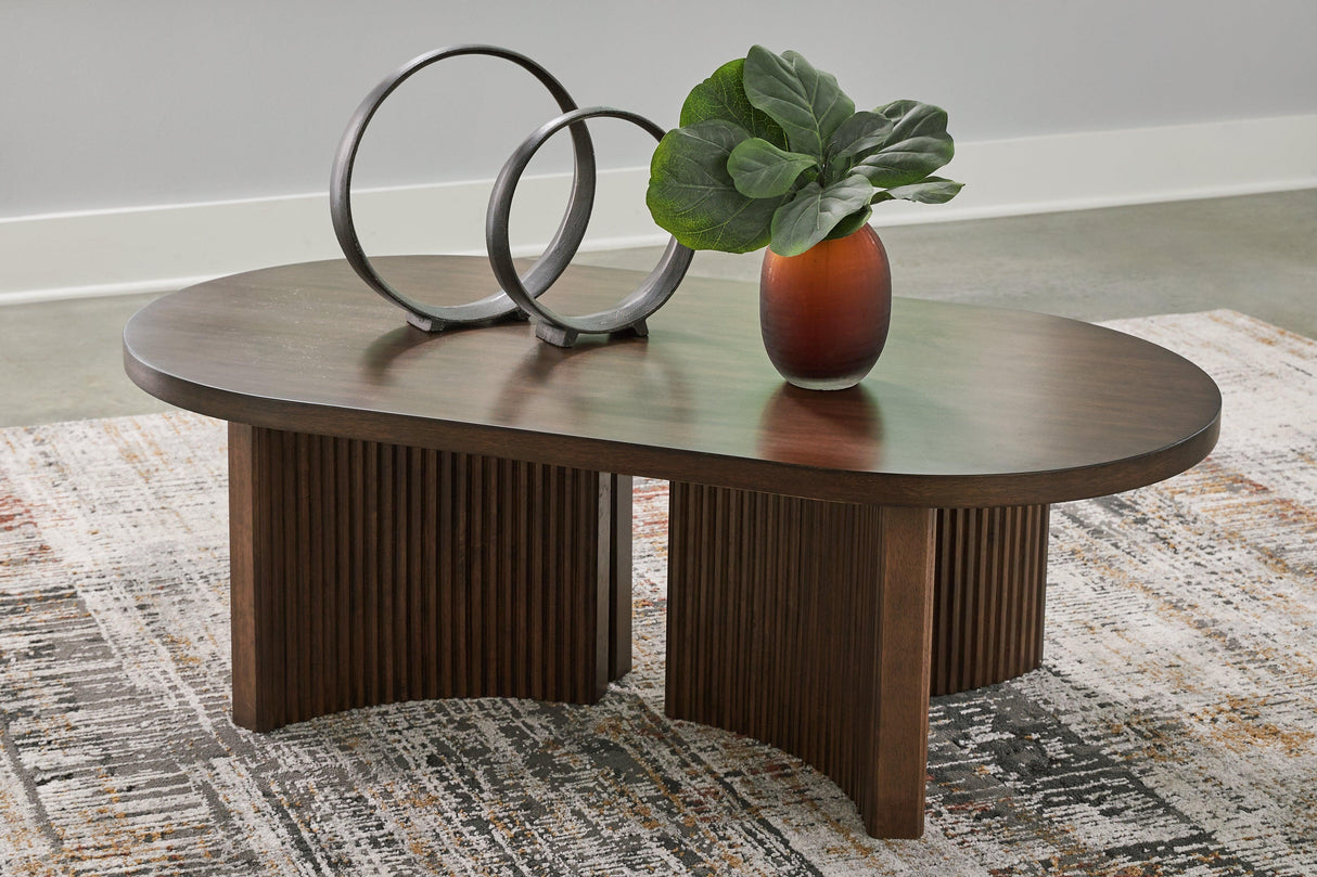 Korestone Dark Brown Coffee Table by Ashley at Eve Furniture