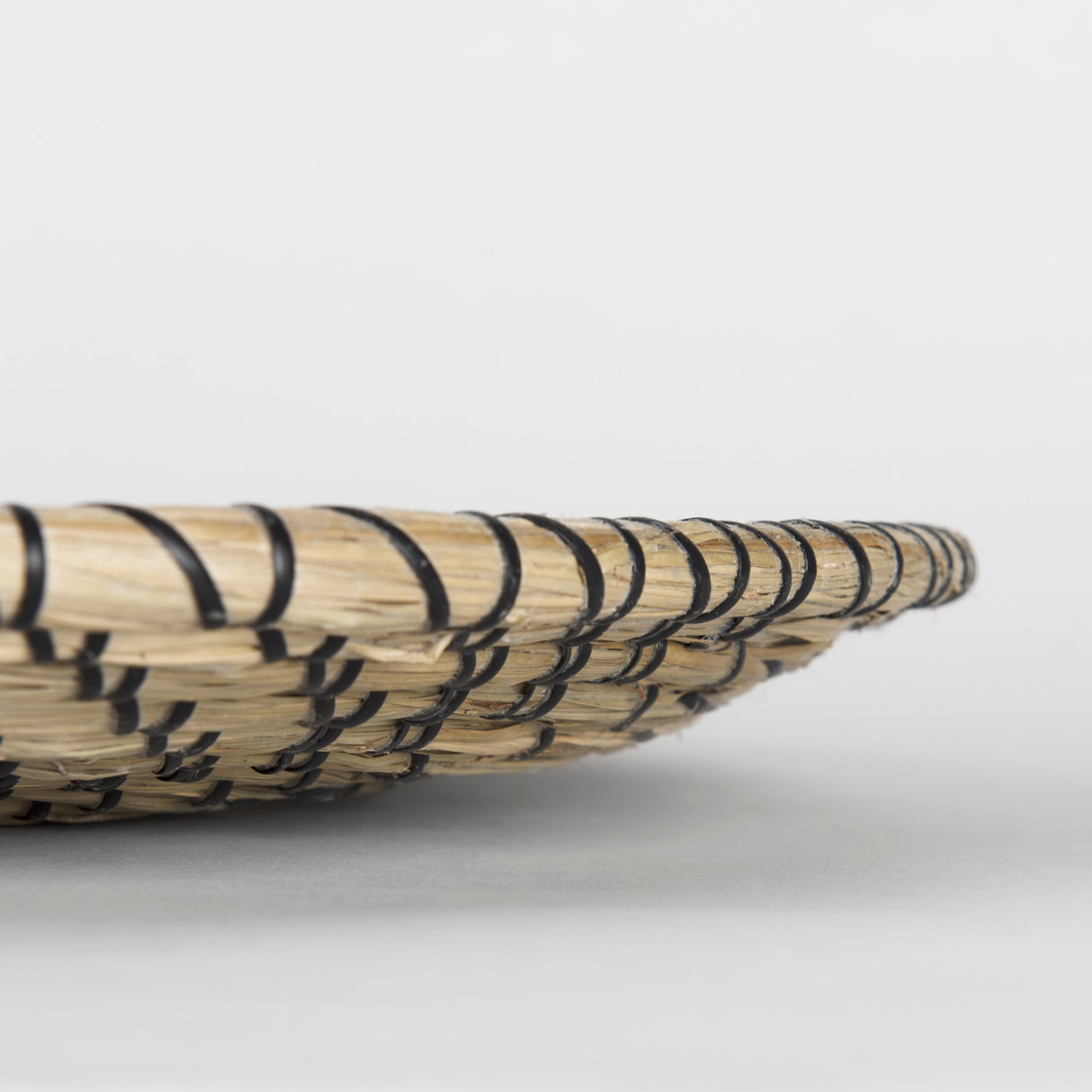 Mekhi Light Brown Seagrass W/Black String Round Wall Hanging Plate by Mercana at Eve Furniture