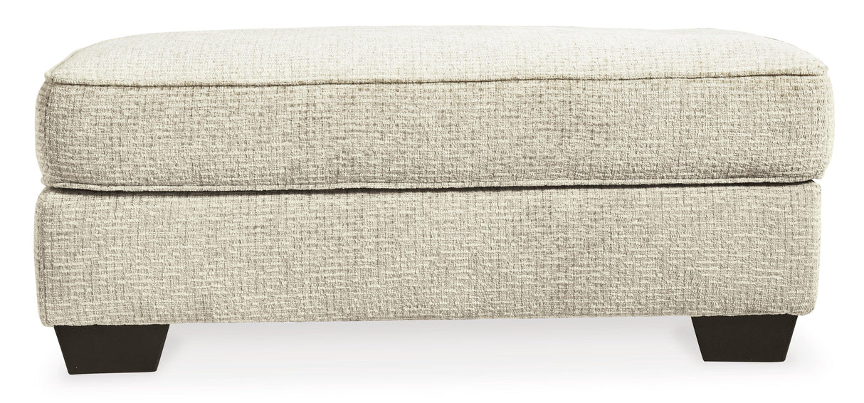 Monaghan Sandstone Ottoman by Ashley at Eve Furniture