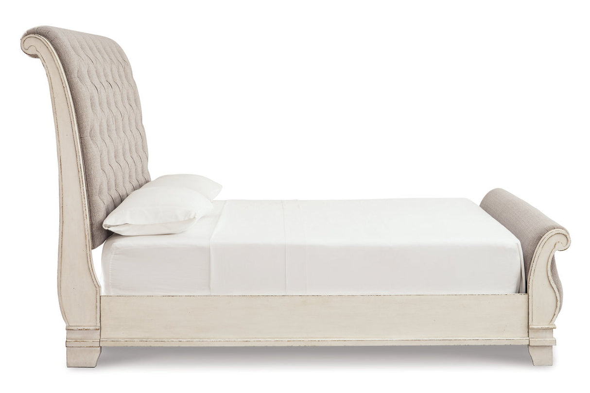 Realyn Chipped White Upholstered Sleigh Bedroom Set by Ashley at Eve Furniture
