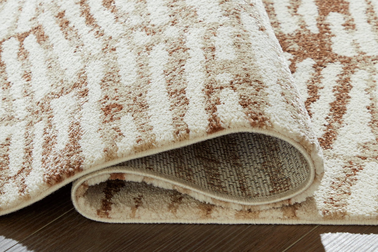 Uduak Cream/Tan/Rust Large Rug by Ashley at Eve Furniture
