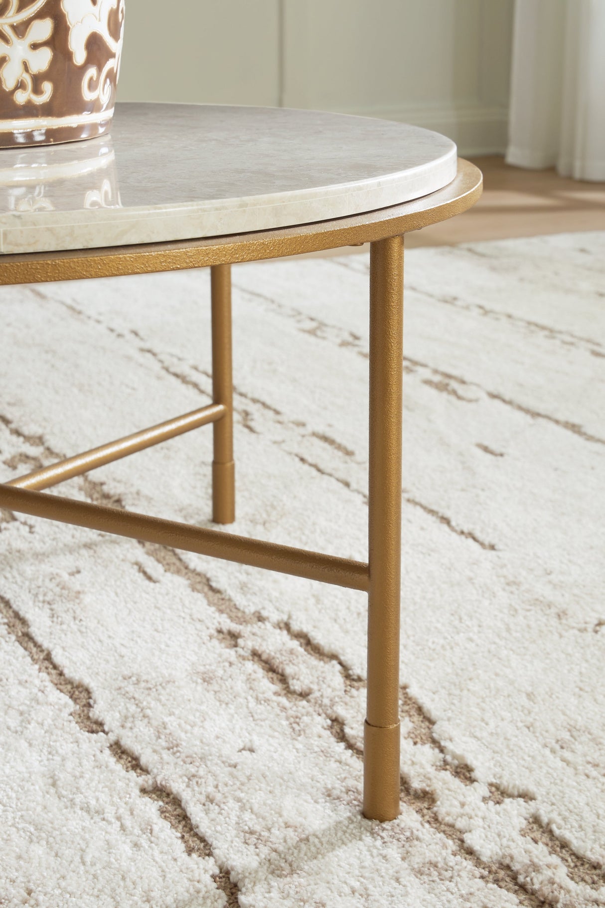 Alben Antique Gold Coffee Table by Ashley at Eve Furniture