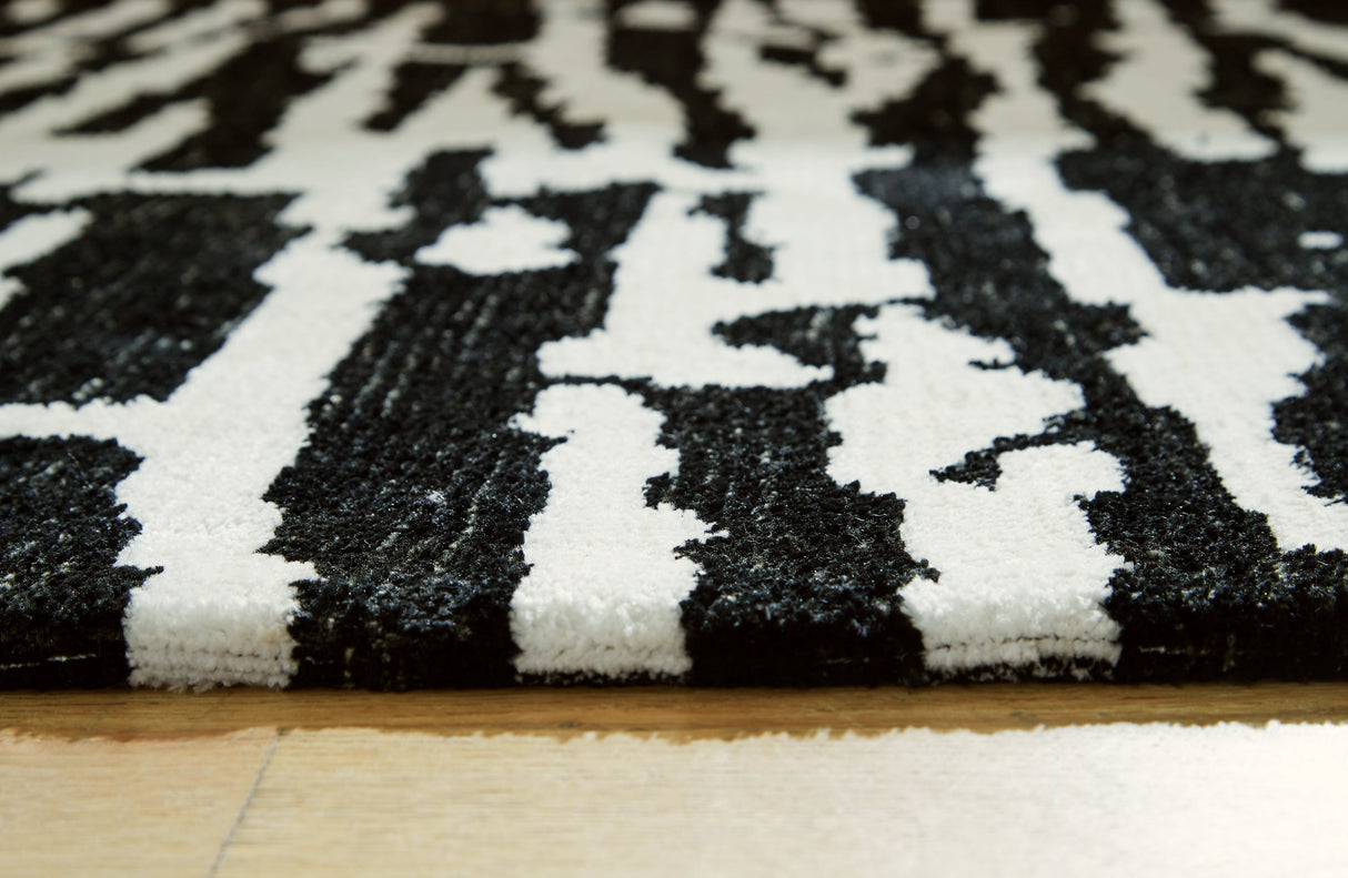 Bramshaw Black/Ivory Extra Large Rug by ASHLEY FURNITURE at Eve Furniture
