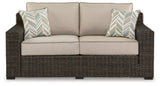 Coastline Bay Brown Outdoor Loveseat with Cushion by Ashley at Eve Furniture