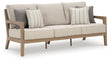 Hallow Creek Driftwood Outdoor Sofa with Cushion by Ashley at Eve Furniture
