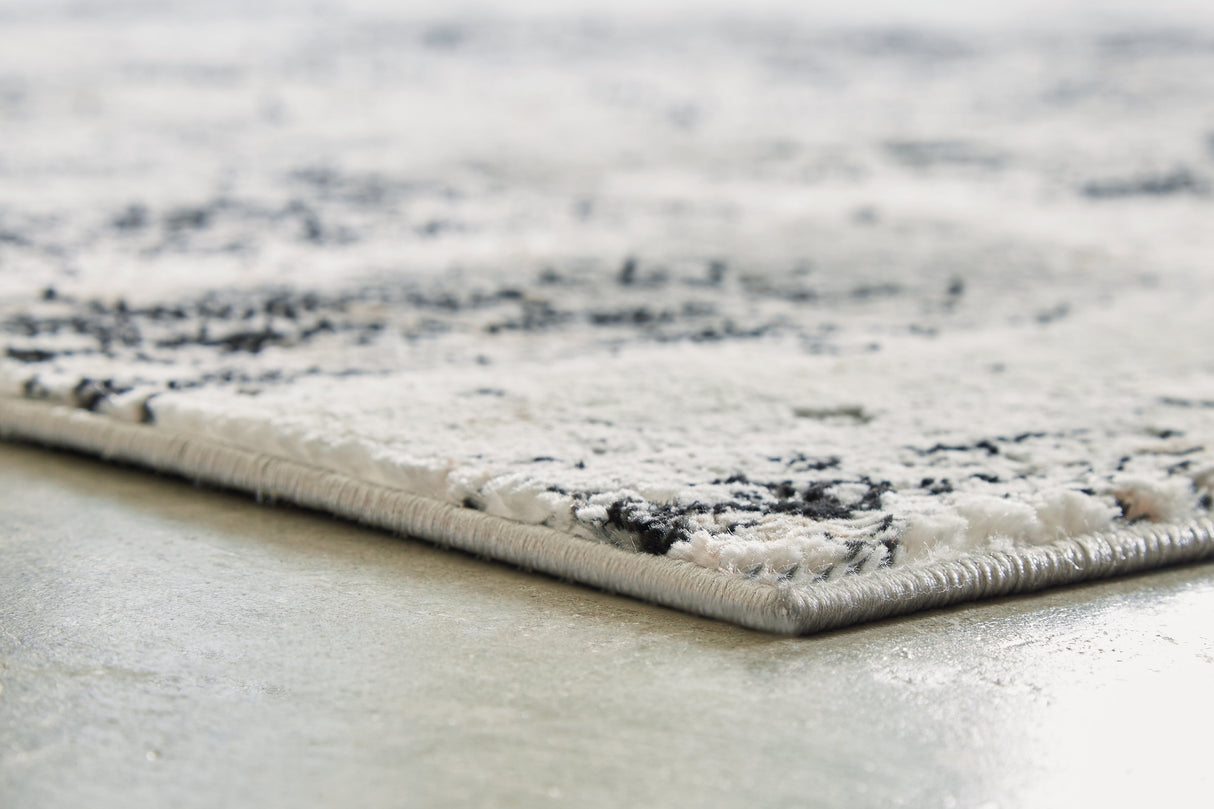 Langwell Black/Gray/White Medium Rug by Ashley at Eve Furniture