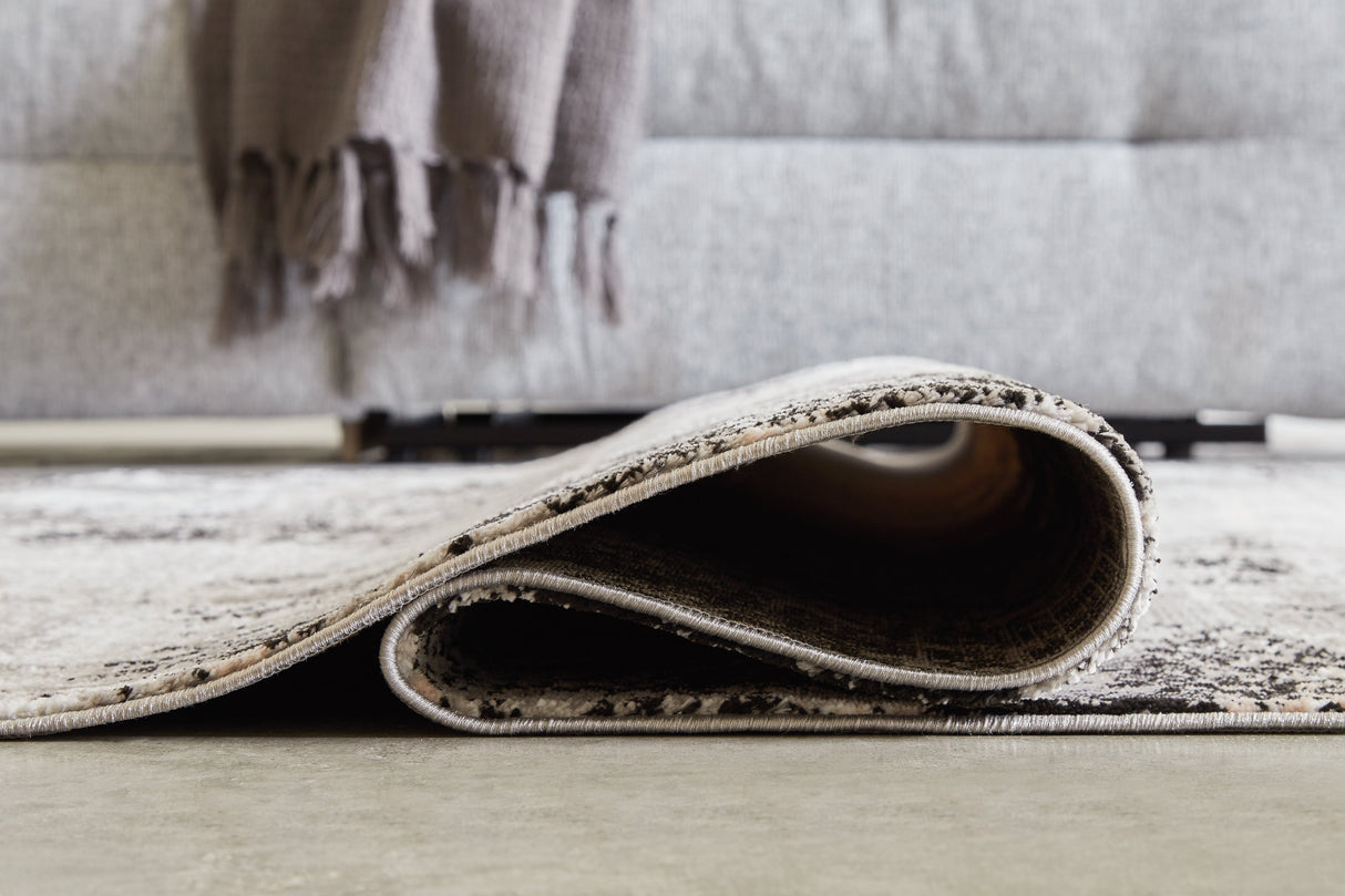 Langwell Black/Gray/White Medium Rug by Ashley at Eve Furniture