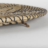 Mekhi Light Brown Seagrass W/Black String Round Wall Hanging Plate by Mercana at Eve Furniture