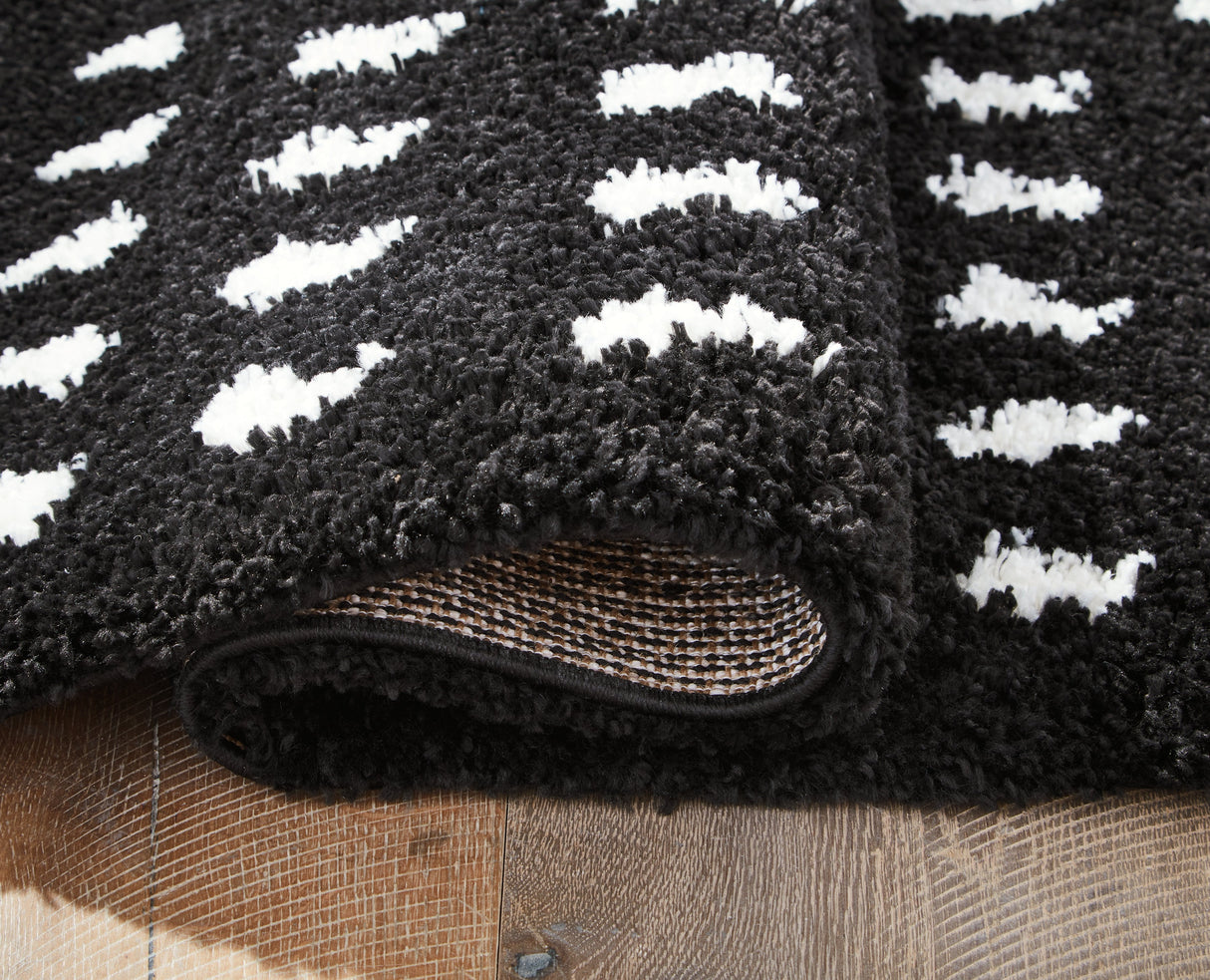 Minston Black/White 5' x 7' Rug by Ashley at Eve Furniture