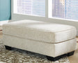 Monaghan Sandstone Ottoman by Ashley at Eve Furniture