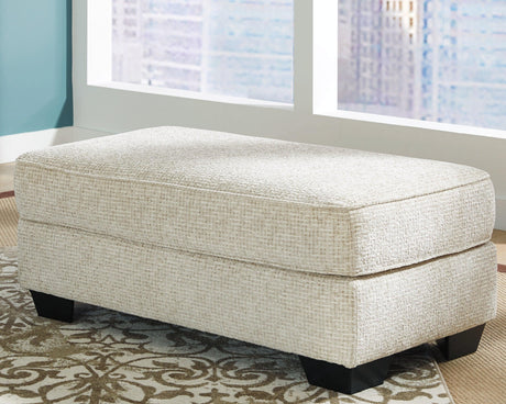Monaghan Sandstone Ottoman by Ashley at Eve Furniture