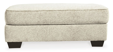 Monaghan Sandstone Ottoman by Ashley at Eve Furniture
