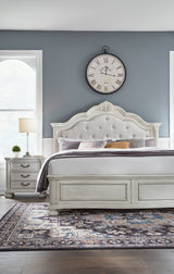 Montelaine Antique White California King Upholstered Panel Bed by Ashley at Eve Furniture