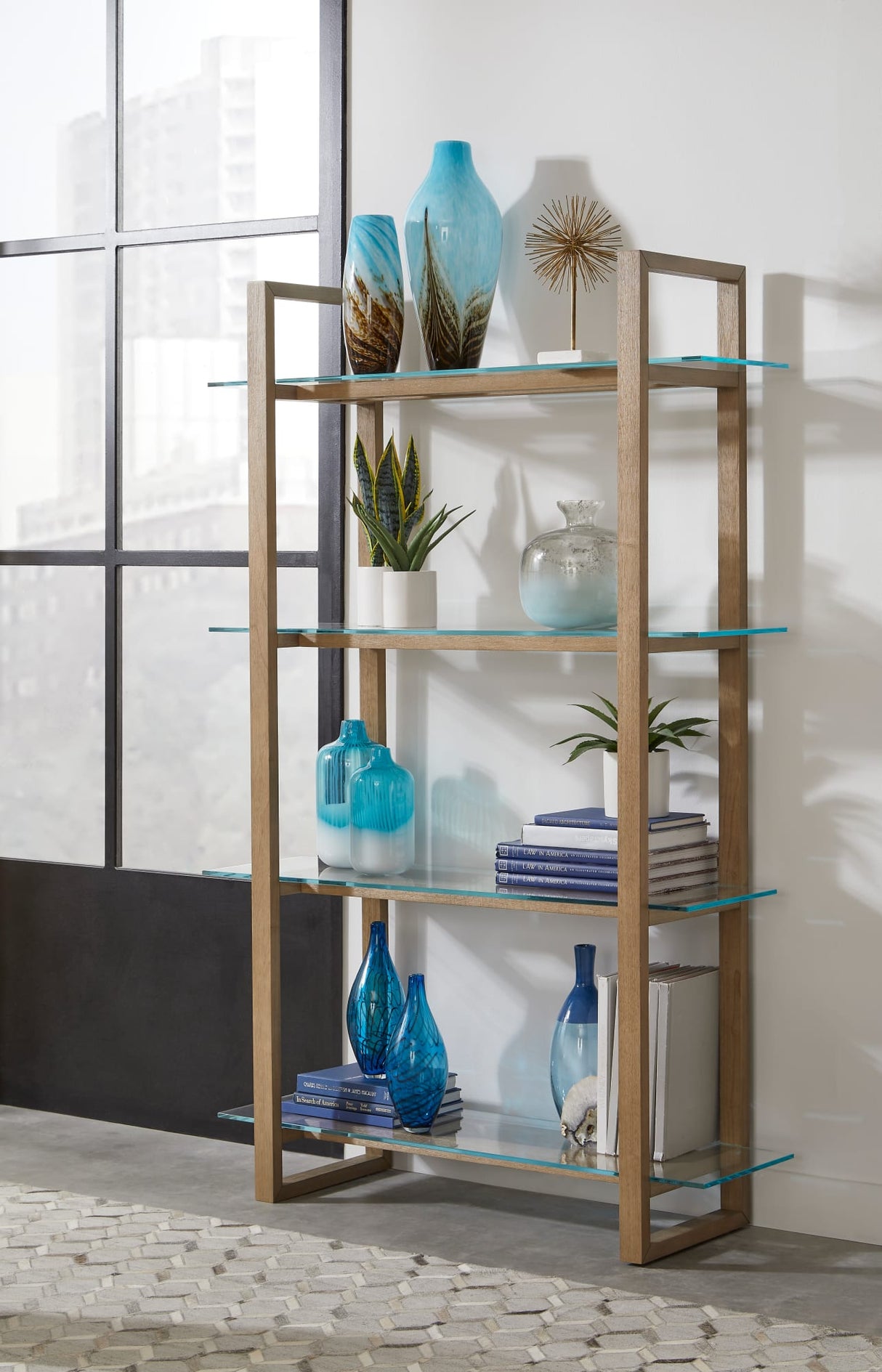 One Bisque/Clear Modern Coastal Glass Shelf Bookcase by Modus Furniture at Eve Furniture