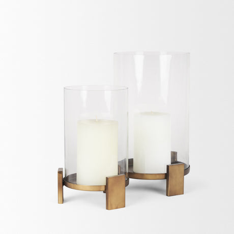 Price Large Antiqued Gold Metal w/ Glass Hurricane Candle Holder by Mercana at Eve Furniture