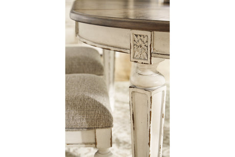 Realyn Chipped White Oval Dining Table and 6 Ladder Back Chairs by Ashley at Eve Furniture