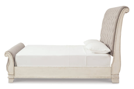 Realyn Chipped White Upholstered Sleigh Bedroom Set by Ashley at Eve Furniture