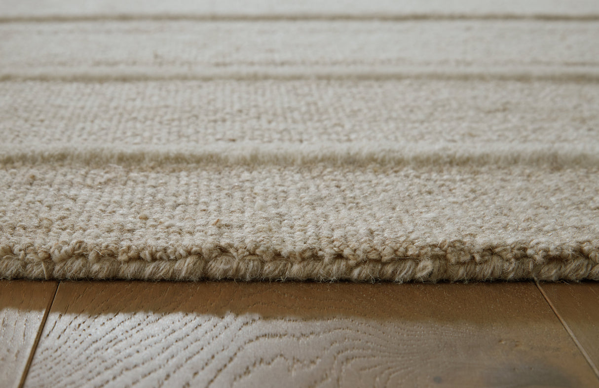 Teelgan Ivory/Tan Extra Large Rug by ASHLEY FURNITURE at Eve Furniture