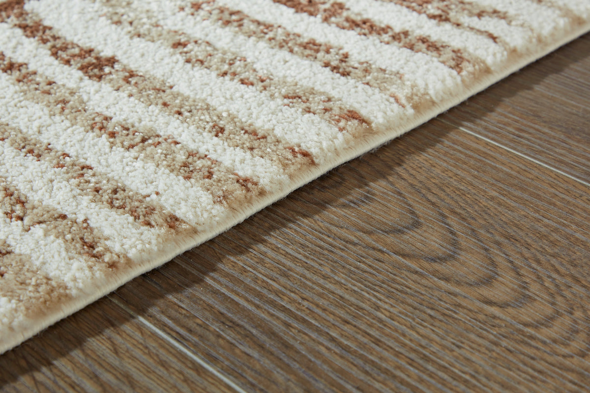 Uduak Cream/Tan/Rust Large Rug by Ashley at Eve Furniture