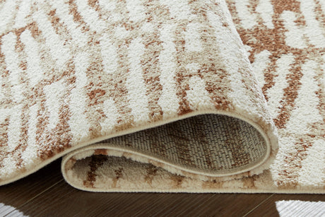 Uduak Cream/Tan/Rust Large Rug by Ashley at Eve Furniture