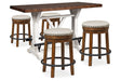 Valebeck Counter Height Dining Room Set In White and Brown by Ashley at Eve Furniture